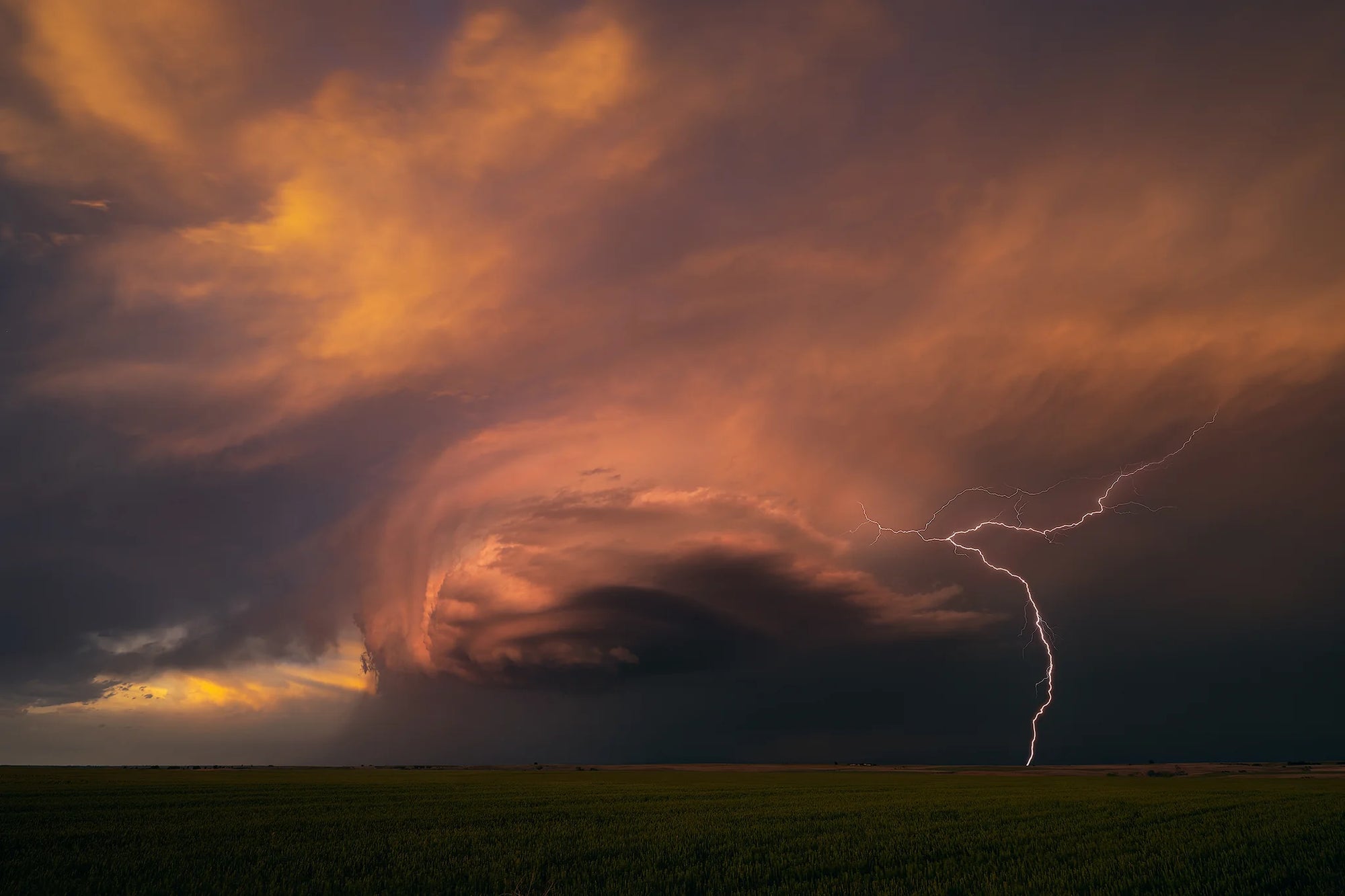 A beautiful thunderstorm base wraps the last light of sunset in Oklahoma