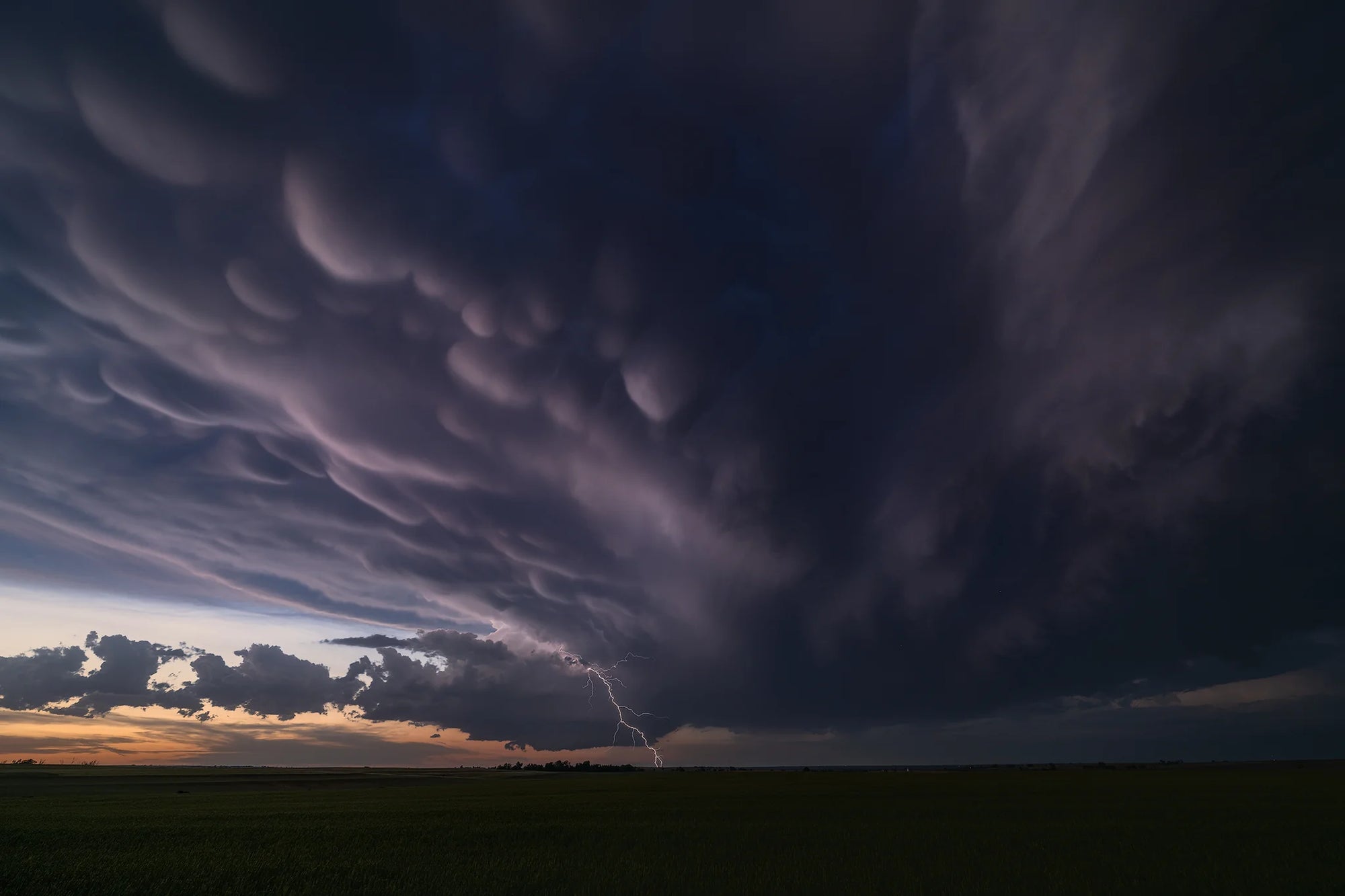Mammatus clouds catch the waning light across the great plains.